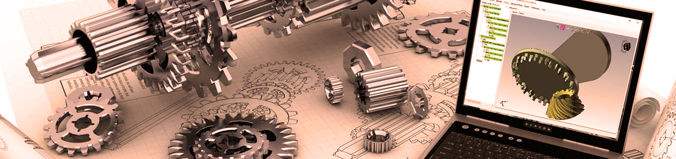 gears on top of schematics with a computer opened and working on rendered gears