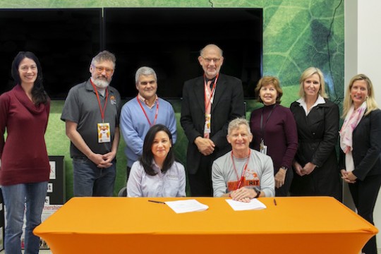 Nine representatives from RIT and Foodlink pose for a photo together.