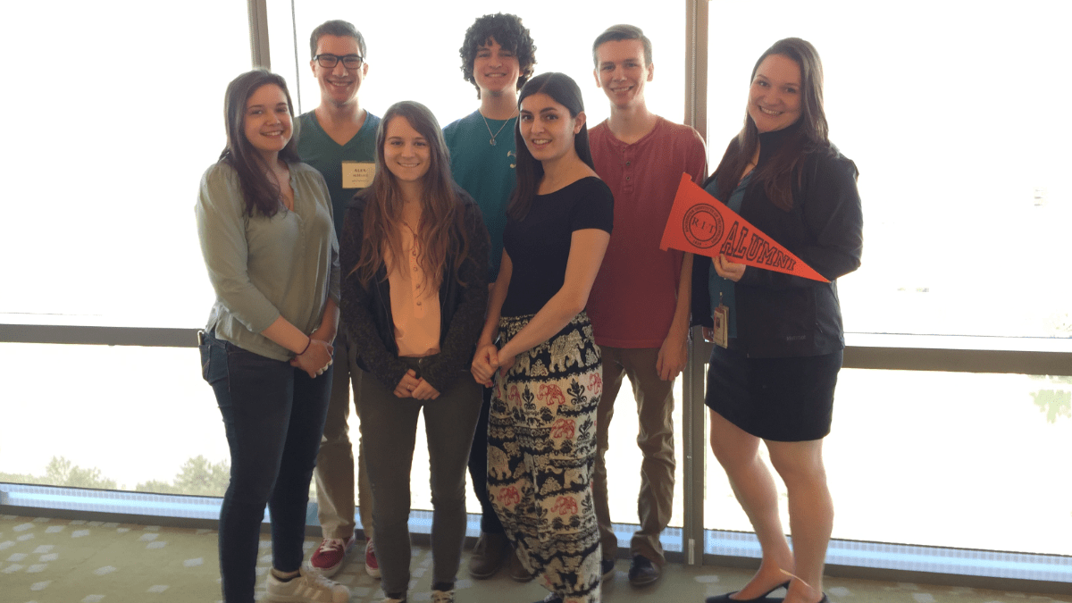 Image of Honors Alumni Standing together in front of a window