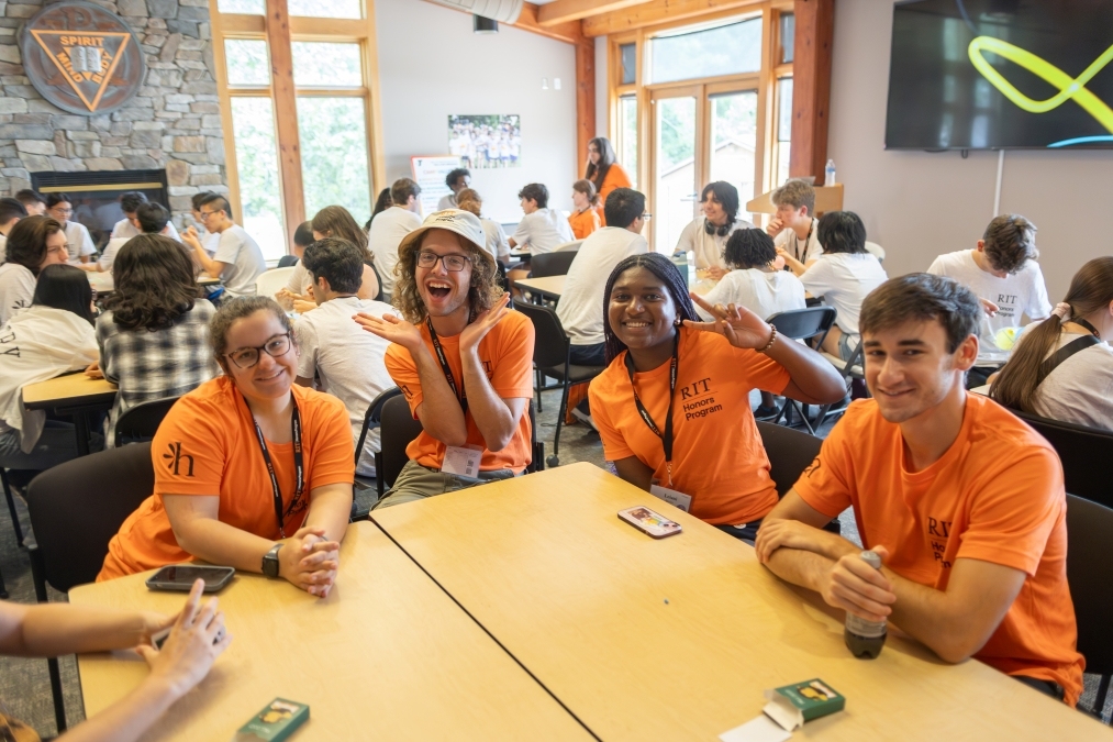Four Honors Mentors in orange shirts during Egg Drop activity