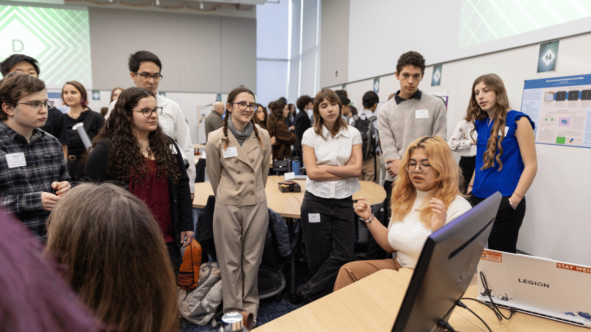 Students at the Research and Creativity Symposium listening to each other's presentations