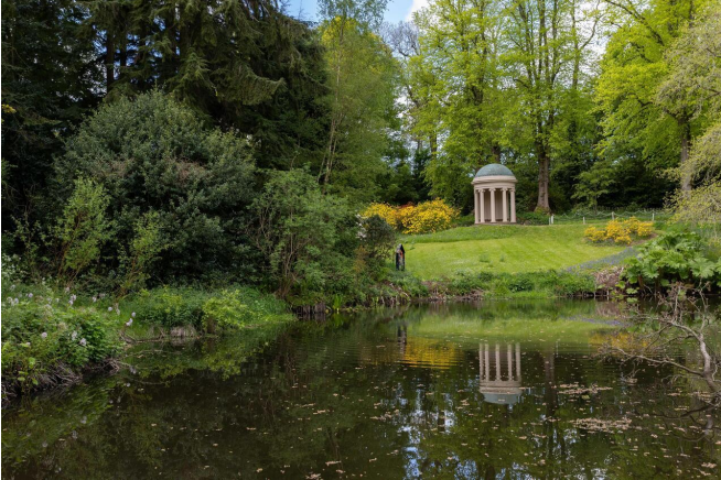 Wooded Green Area with open mowed grass past a pond