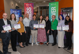 A group picture of people standing with certificates