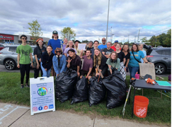 Group of people standing outside with trash bags 