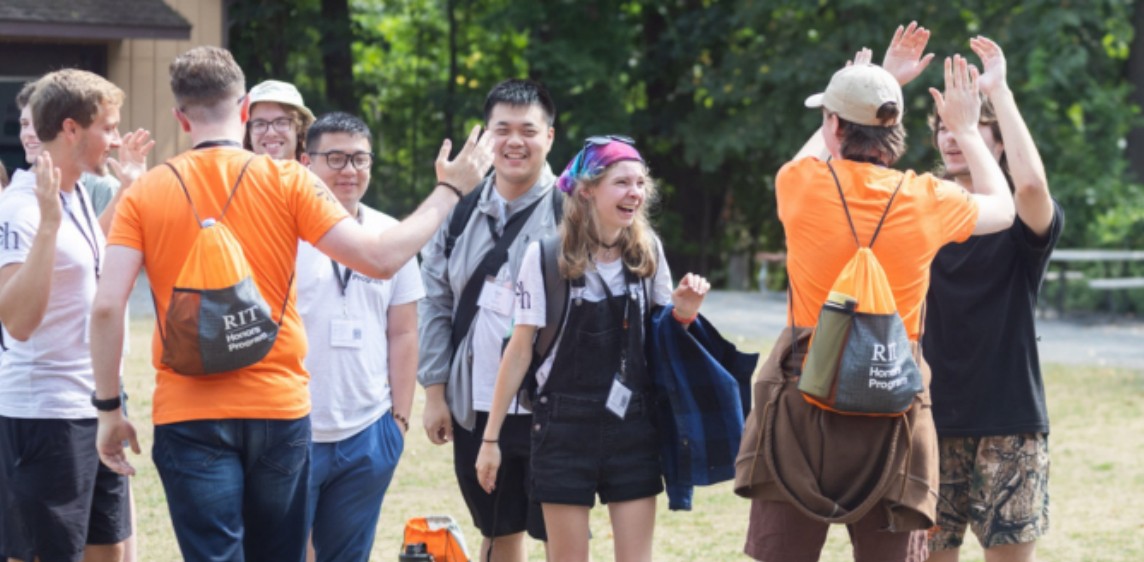 Multiple students high-fiving