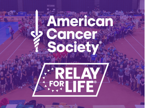 Photo of students at Relay For Life of RIT making a ribbon with ACS and Relay For Life Logos