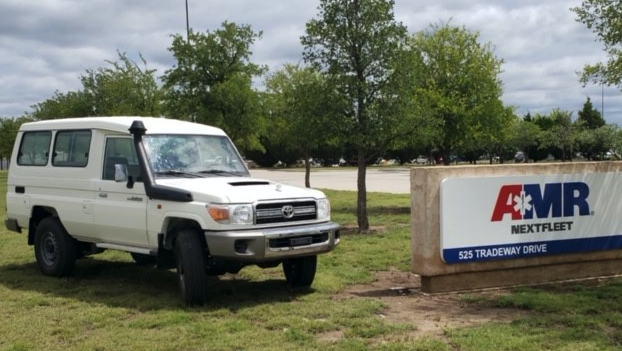 Toyota Landcruiser next to American Medical Response sign