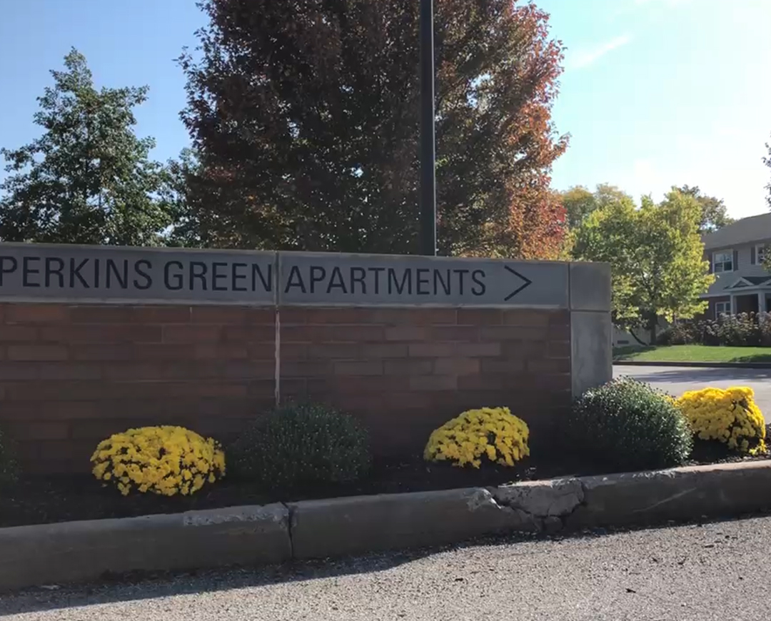 brick sign saying "Perkins Green Apartments"