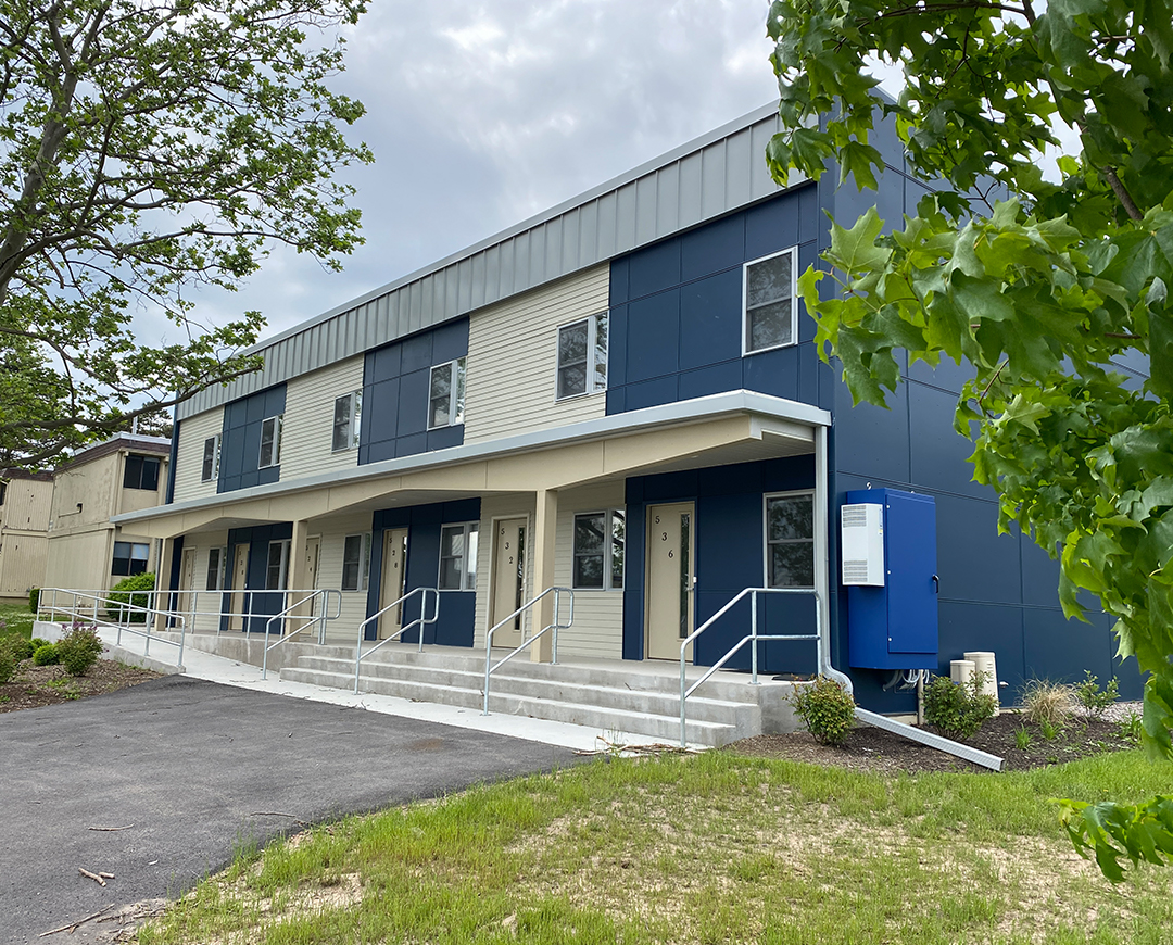exterior of Riverknoll building. blue and cream paint separates the townhomes
