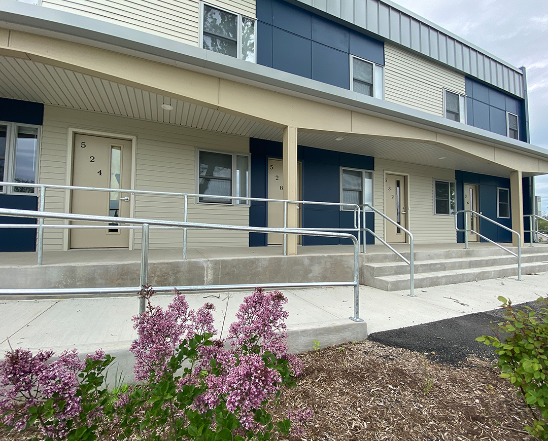 exterior of Riverknoll building. blue and cream paint separates the townhomes