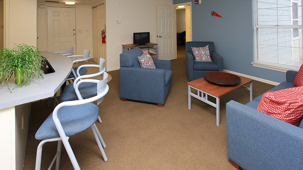 view of open concept living room and kitchen counter with chairs