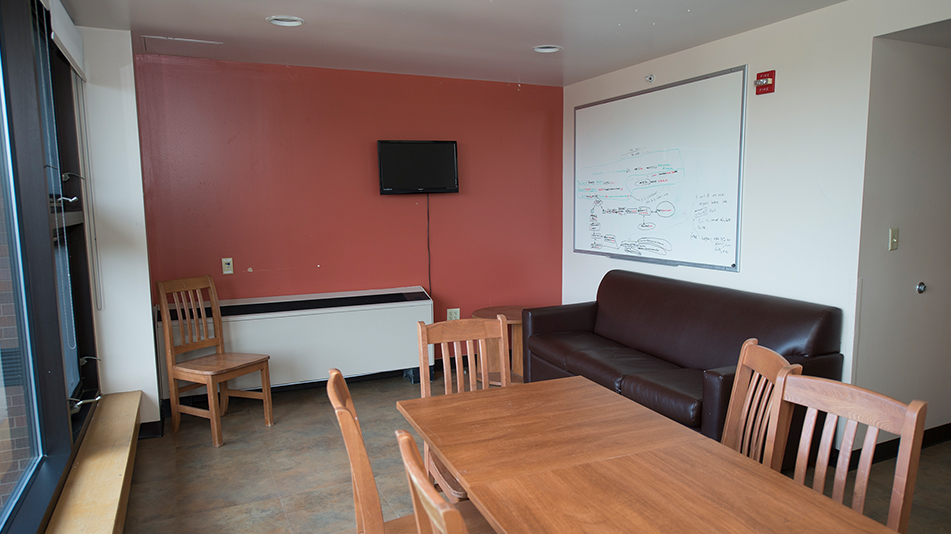 shared lounge with a table, couch, and tv