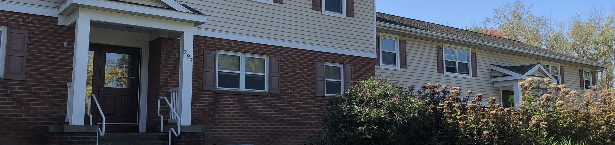 two floor brick and cream siding building