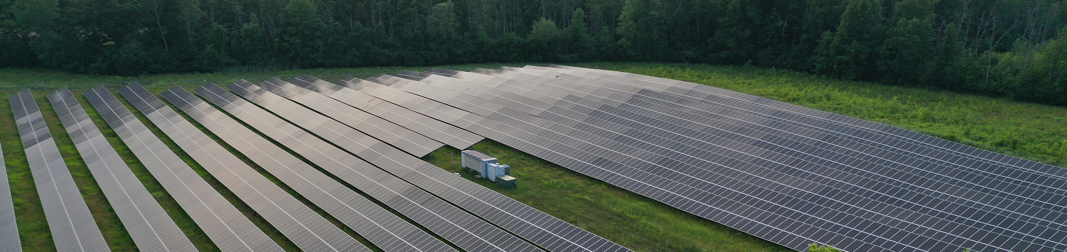 solar field arial shot with green grass field