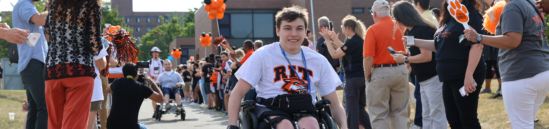 two students who use wheelchairs making their way down the quarter mile during tiger walk ceremony