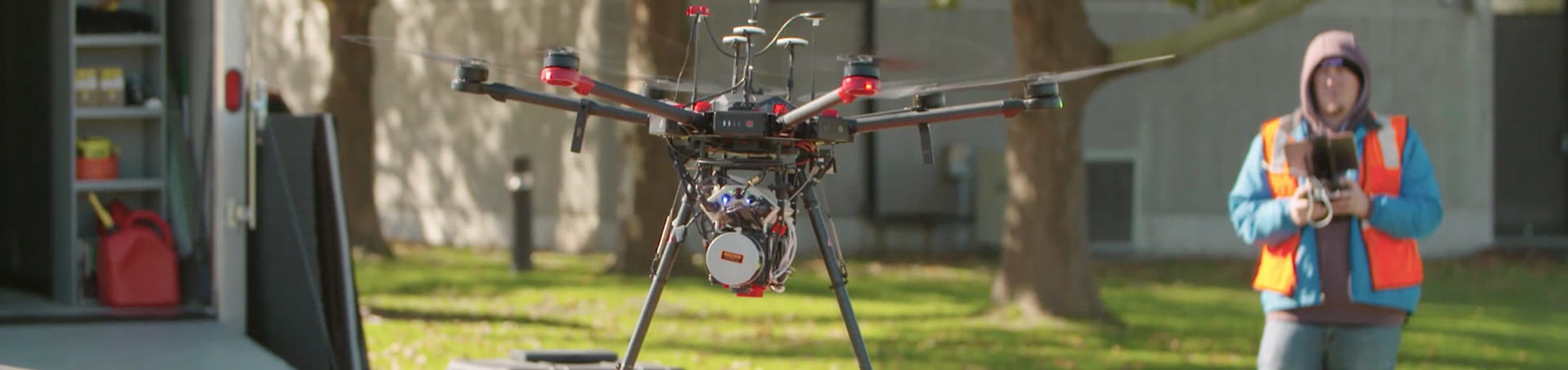 A drone pilot flying a drone with sensors on it