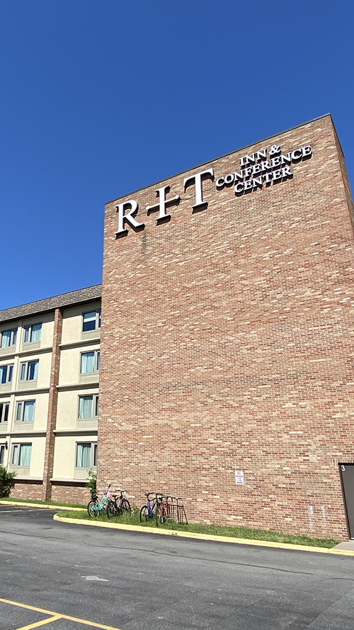 brick four story building with RIT Inn & Conference Center signage