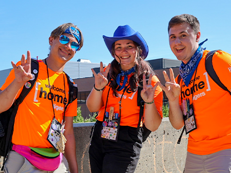 Three students in orange tshirts