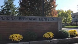 brick sign saying "Perkins Green Apartments"
