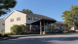 exterior of two floor building, Perkins Green, with awning out front