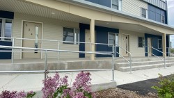 exterior of Riverknoll building. blue and cream paint separates the townhomes