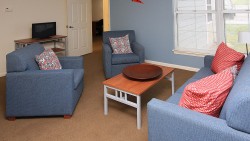 living room with 2 chairs, one couch, and one coffee table