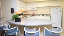 kitchen view with counter and chairs, stove, and refrigerator