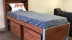 bed with two storage compartments underneath and a headboard