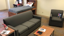 living room with a grey couch and chair, coffee table, and end tables