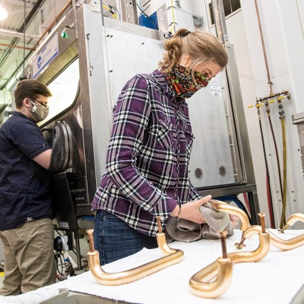 researcher cleaning door handle.