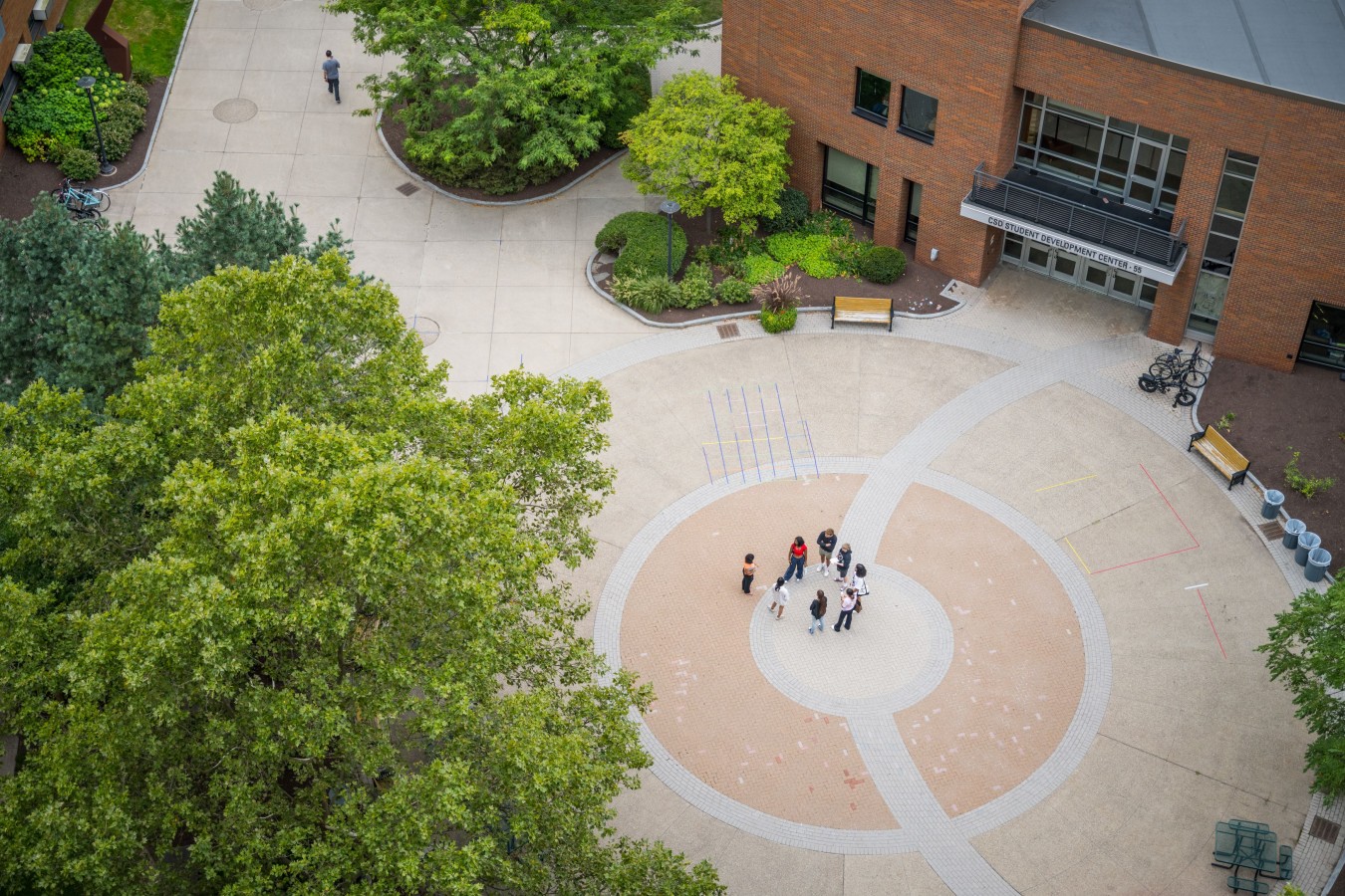 Aerial photo of group of people standing in center of NTID's courtyard