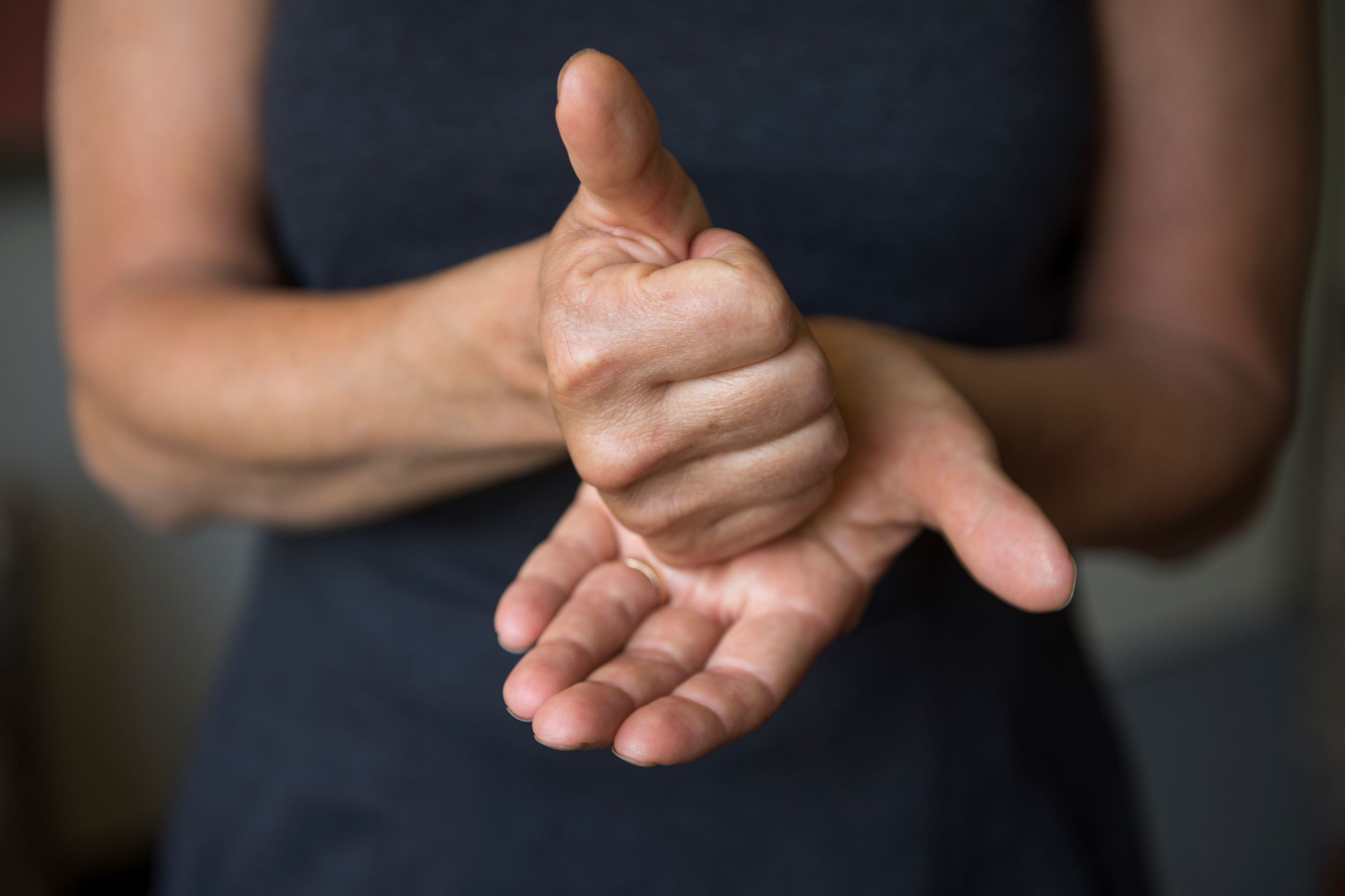 woman signing 'help' in ASL