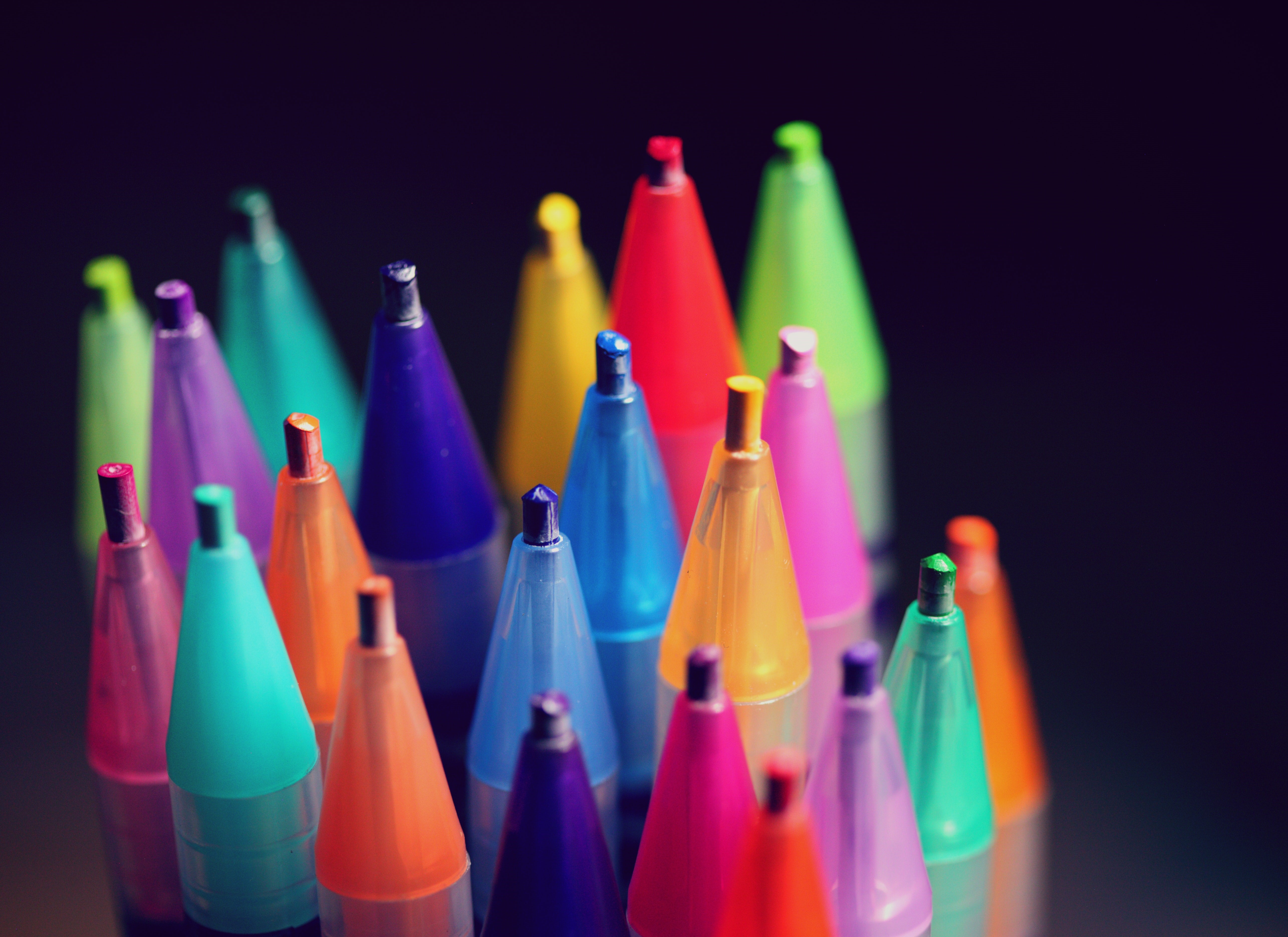 multicolored pencils upright against a black background