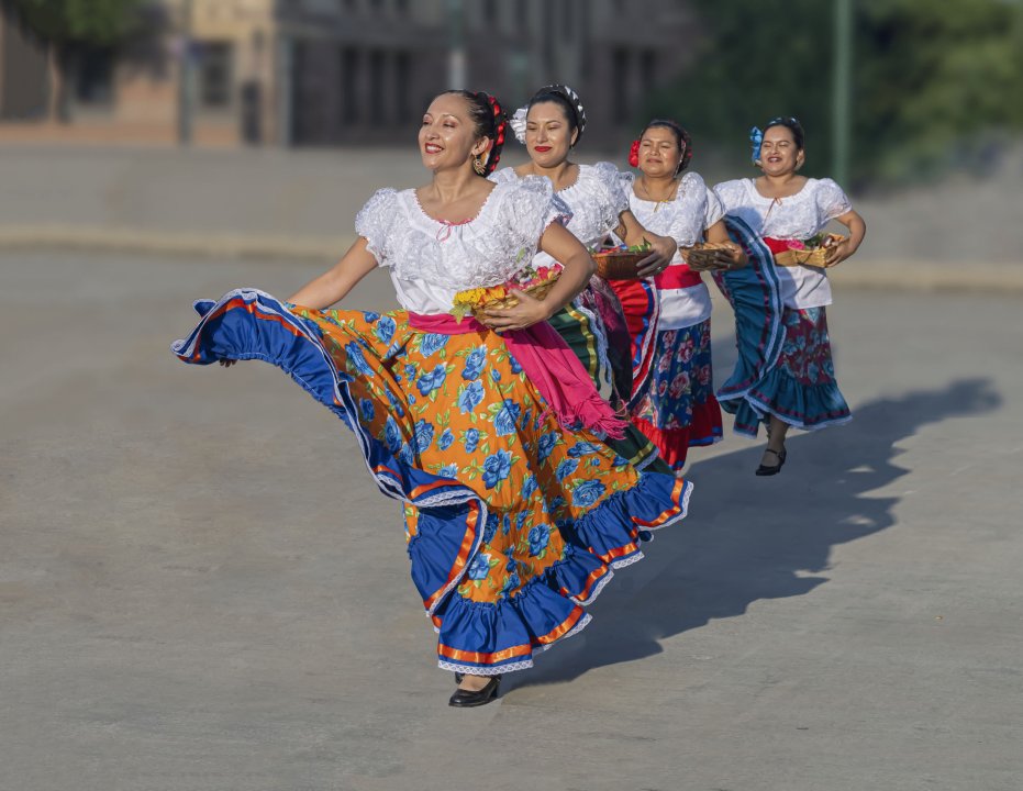 5 beautiful Mexican woman dancing in unison.