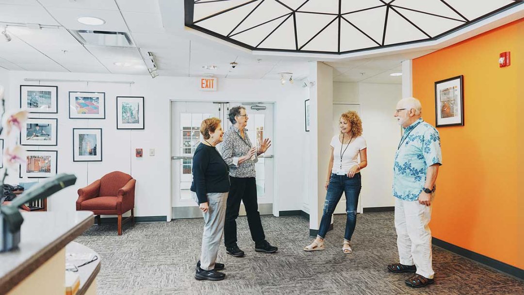 OLLI members chatting in the lobby of the OLLI building