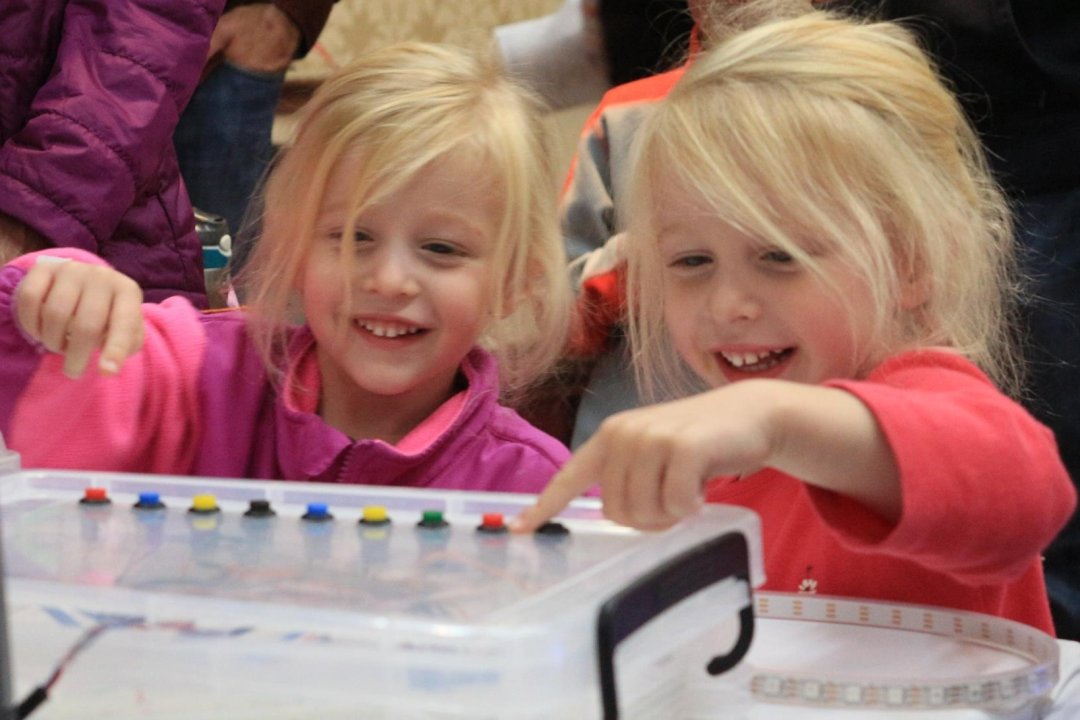 Children laughing while pushing buttons on The Computer Petting Zoo.