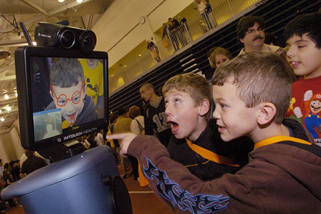 People looking at interactive screen at event