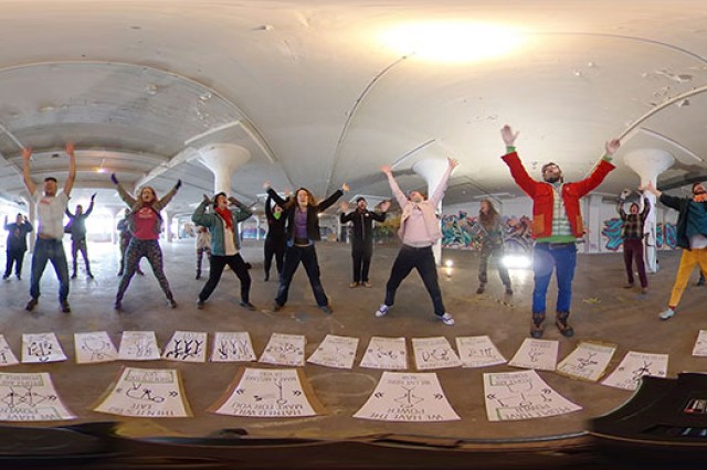 Students pose for 360 video with arms above their heads.