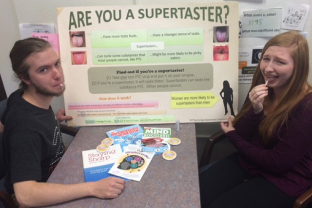 two college students tasting a paper strip.