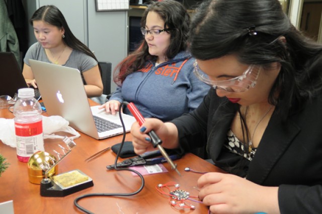 A student works on a soldering project.