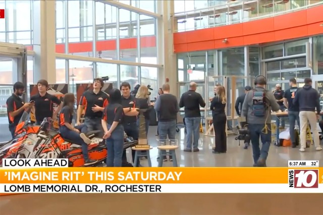 Students are shown gathering around a snowmobile, which is one of the exhibits at Imagine RIT.