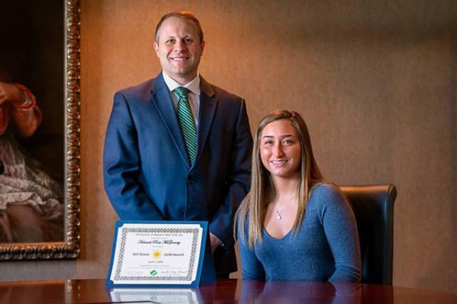 Student and superintendent pose with award.