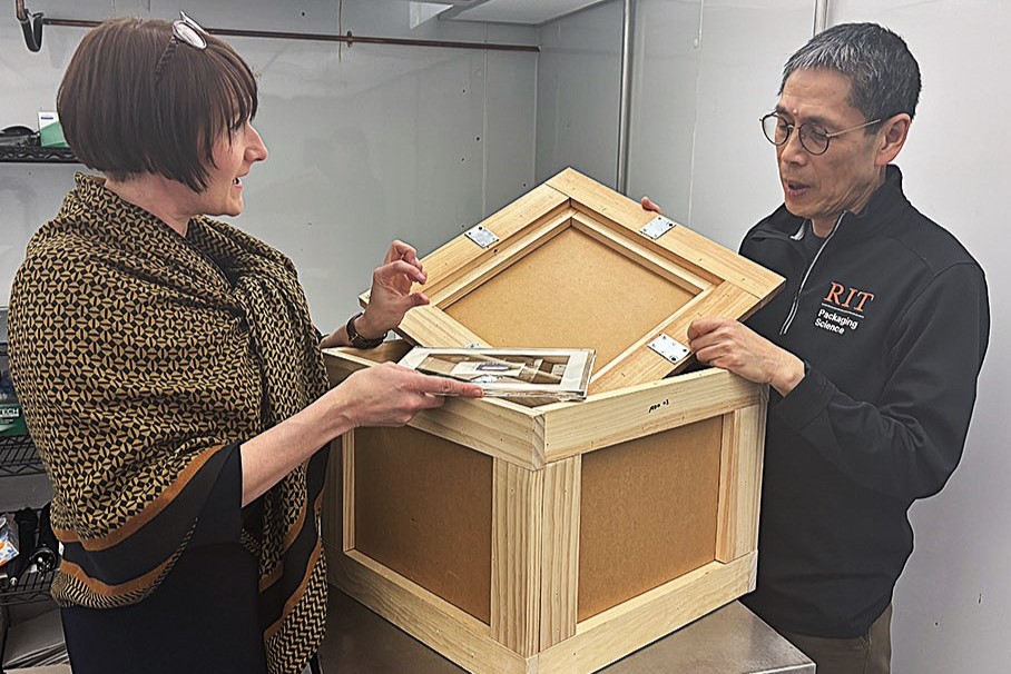Project investigators standing with a crate