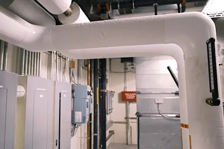 A photo of fuse boxes and PVC pipes.