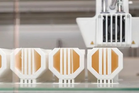 A row of three similar 3D printed objects.