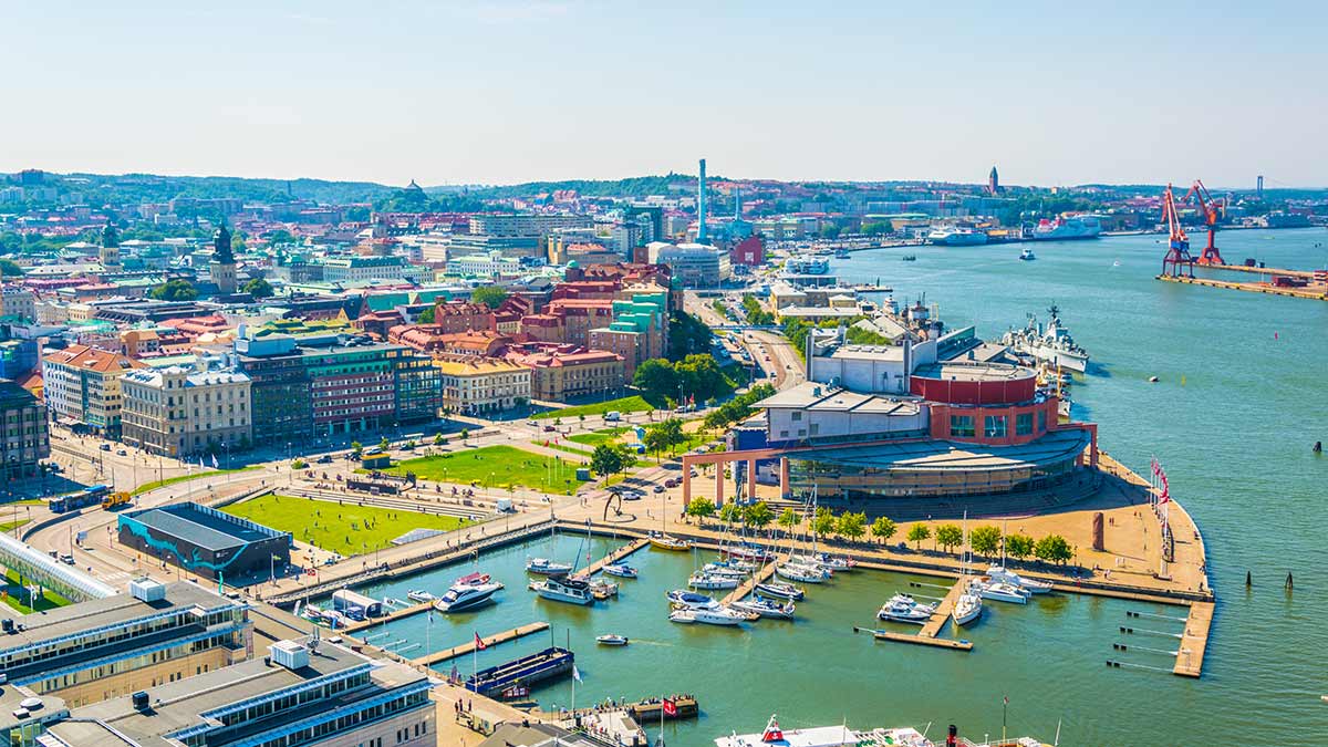 an aerial view of buildings and a body of water in a city in Sweden.