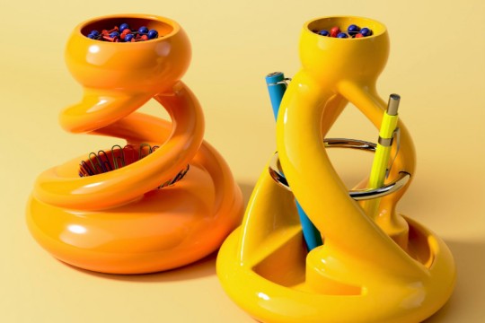 two prototypes of orange and yellow twisting pen holders.