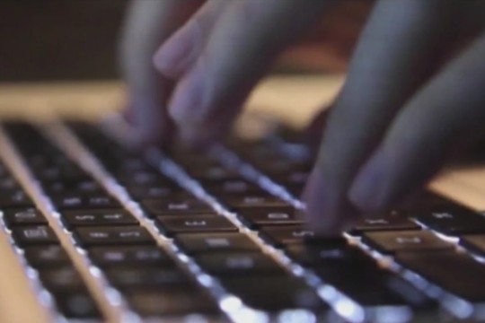 person typing on laptop keyboard.