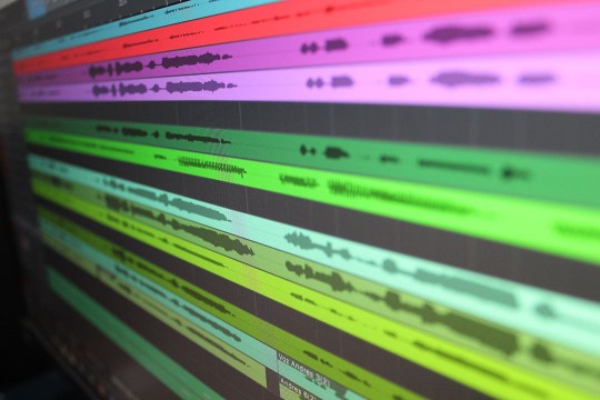computer screen with colorful rows of audio waves.