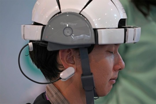 person wearing a helmet with a clip attached to his ear.